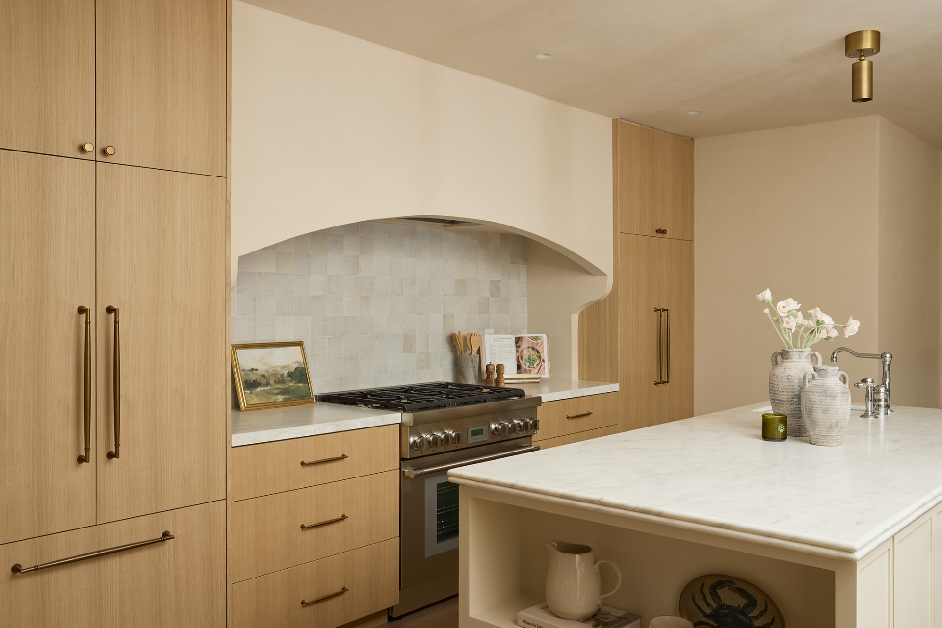 White oak kitchen with marble island, zellige backsplash and brass hardware